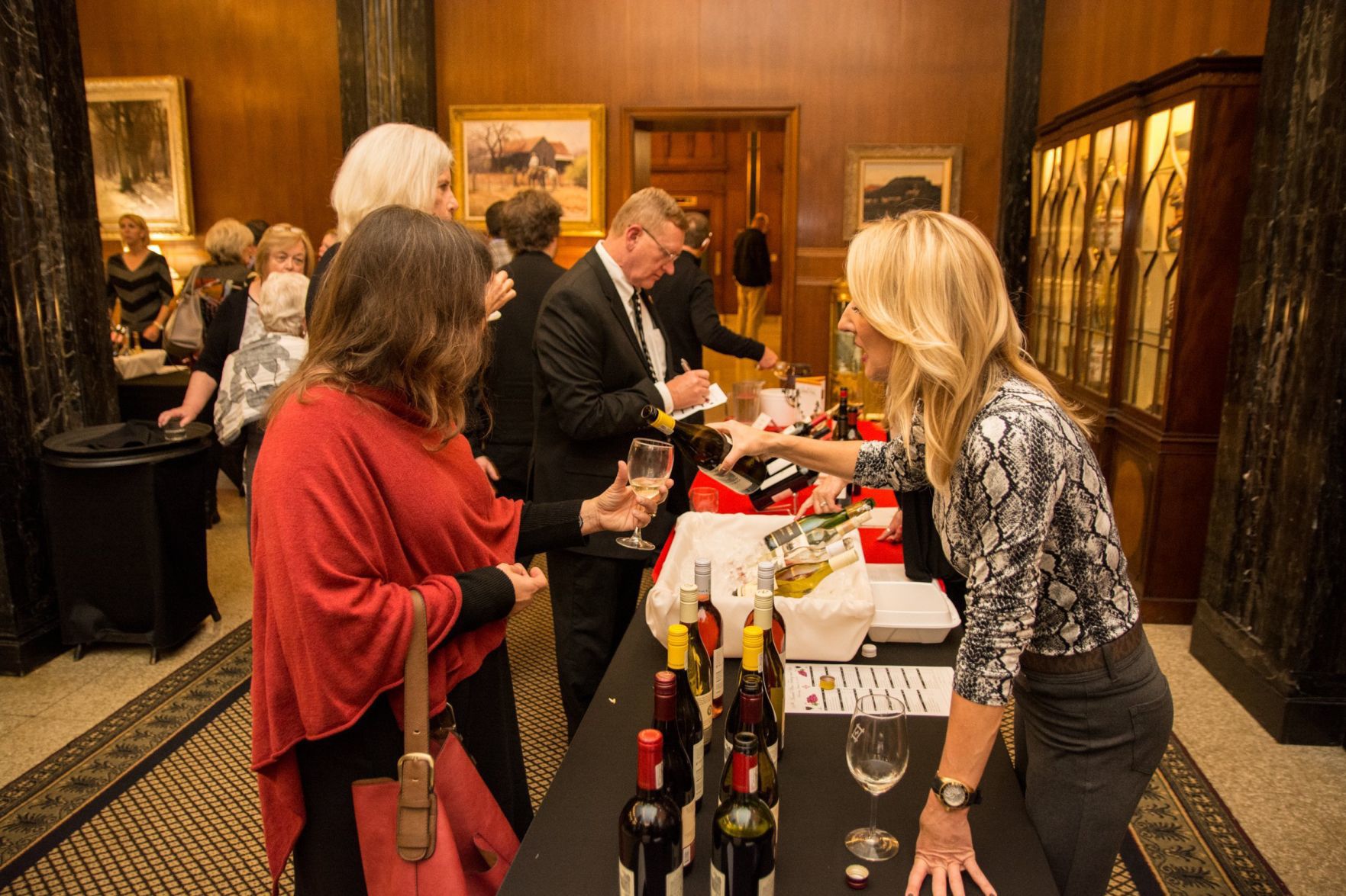 An attendee gets a wine sample